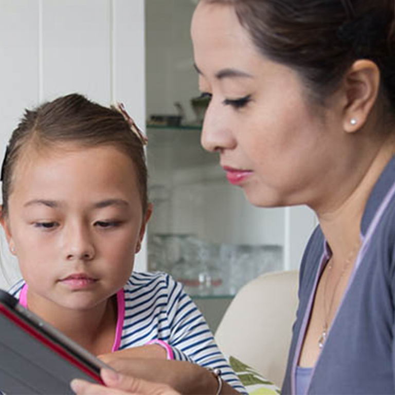 Vrouw met kind kijkt op tablet